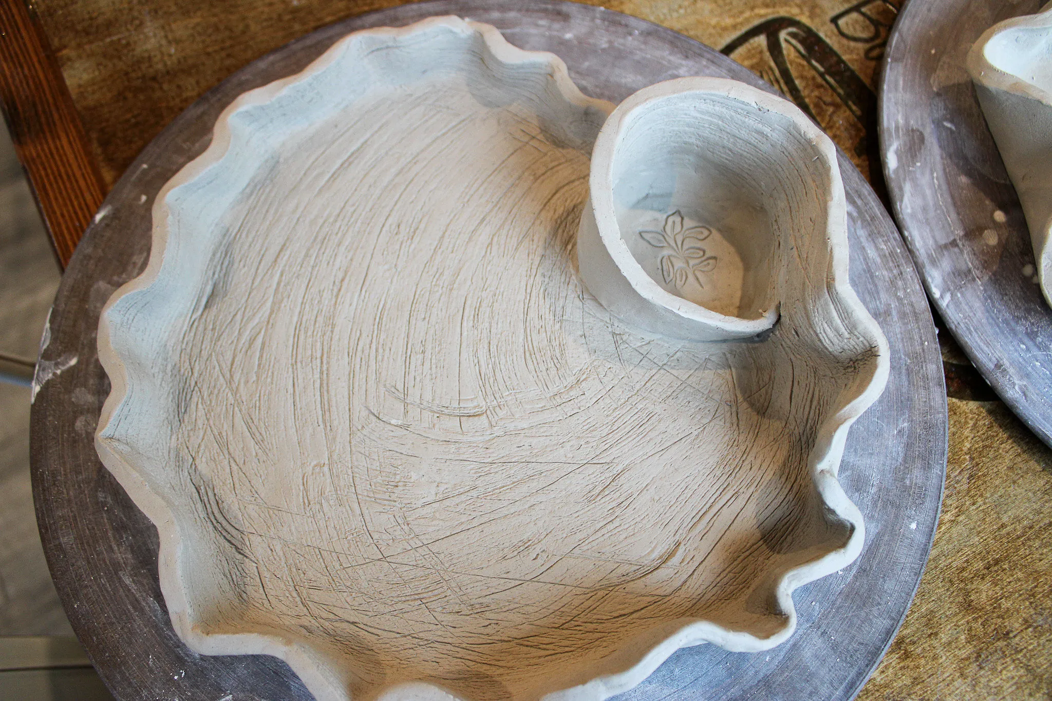 A hand-built scalloped chip-and-dip dish made in a Devine Perks class